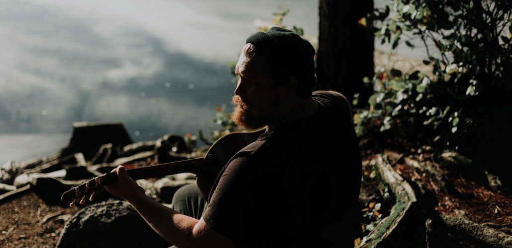 Man playing guitar in nature