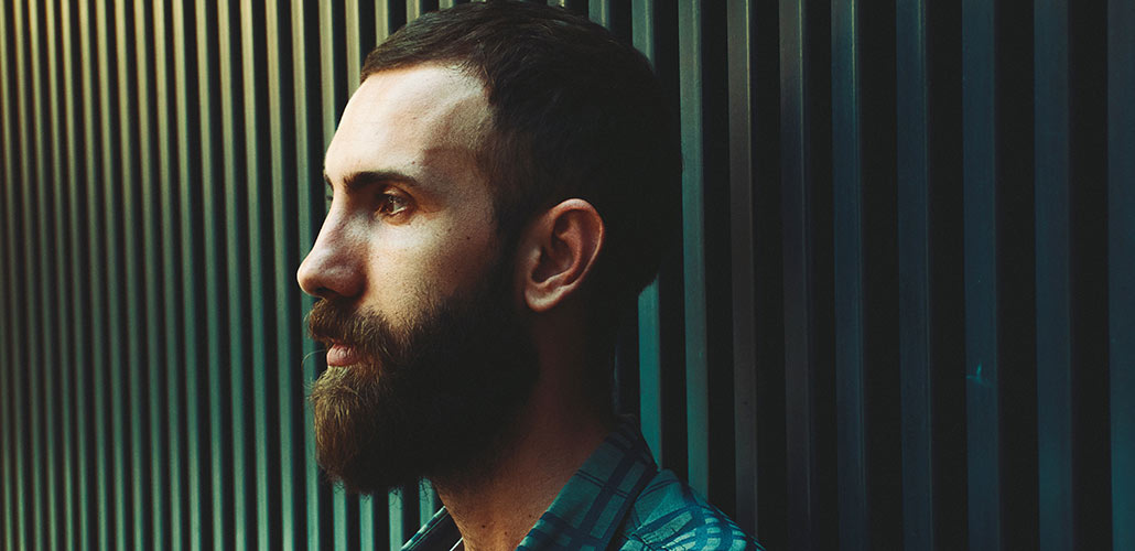 man with beard with head turned facing left