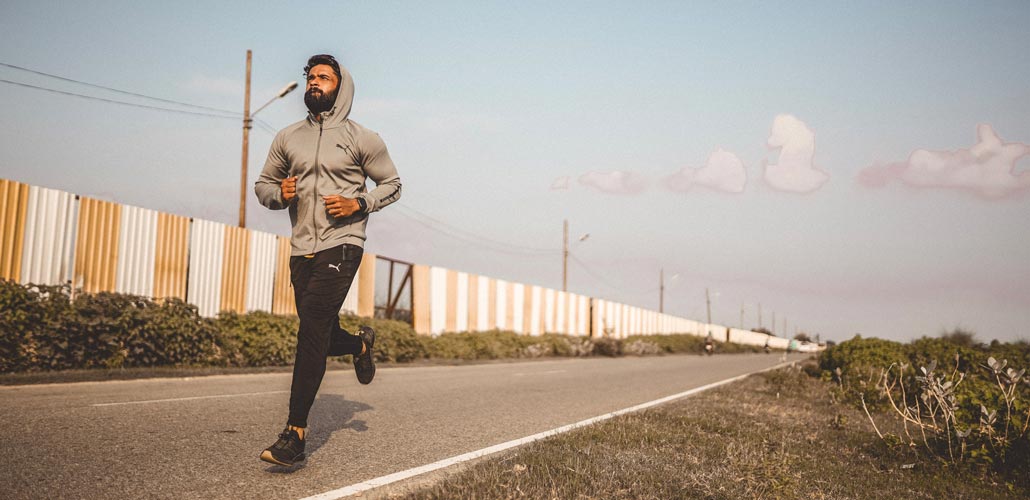 Man jogging along road