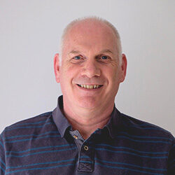 Photo of Andy Wilson in front a grey backdrop