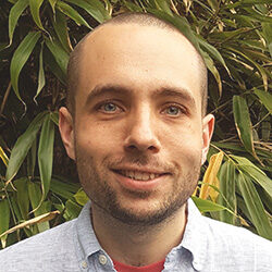 Photo of Ben Rath in front of some plants