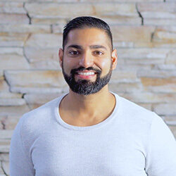 Photo of Amandeep Jassal in front of stone wall