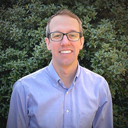 A photo of Dr. Scot Seitz in front of some foliage