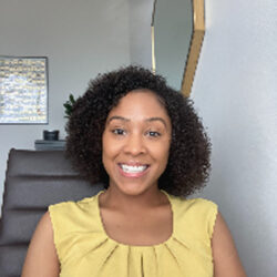 A photo of Dr. Wilson in front of a set of stairs inside a home