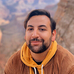 A photo of Franco Bejarano with an out-of-focus mountain vista in the background