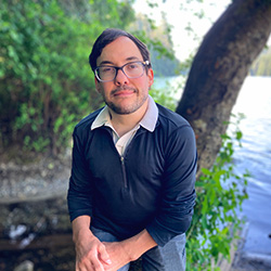 A photo of Kevin Berry posing in front of a tree