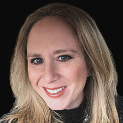 A close-up photo of Pamela Madsen in front of a black background