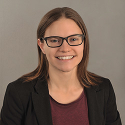 A photo of Dr. Amy Shannon against a neutral grey background