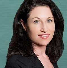 Woman with black hair in front of green