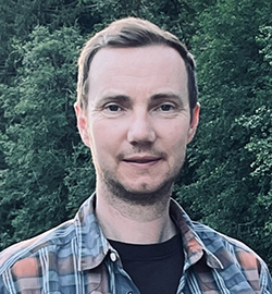 Man in front of trees