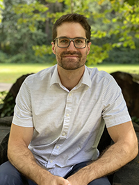 Man in front of grass